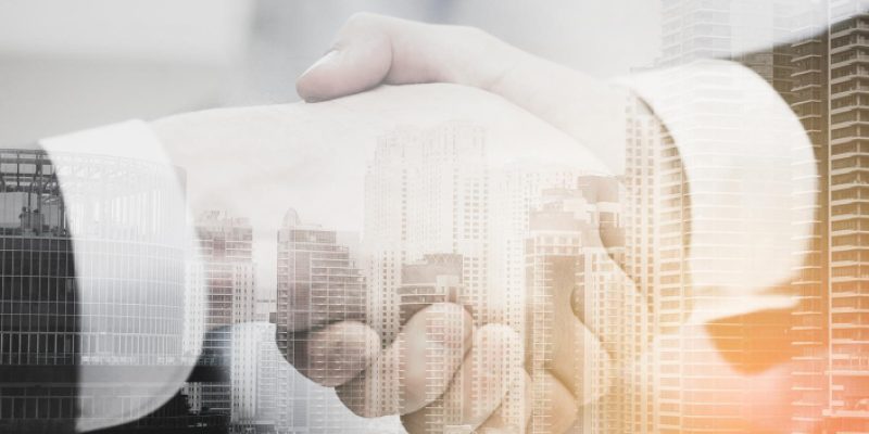 businesss-office-concept-two-businessmen-shaking-hands-office
